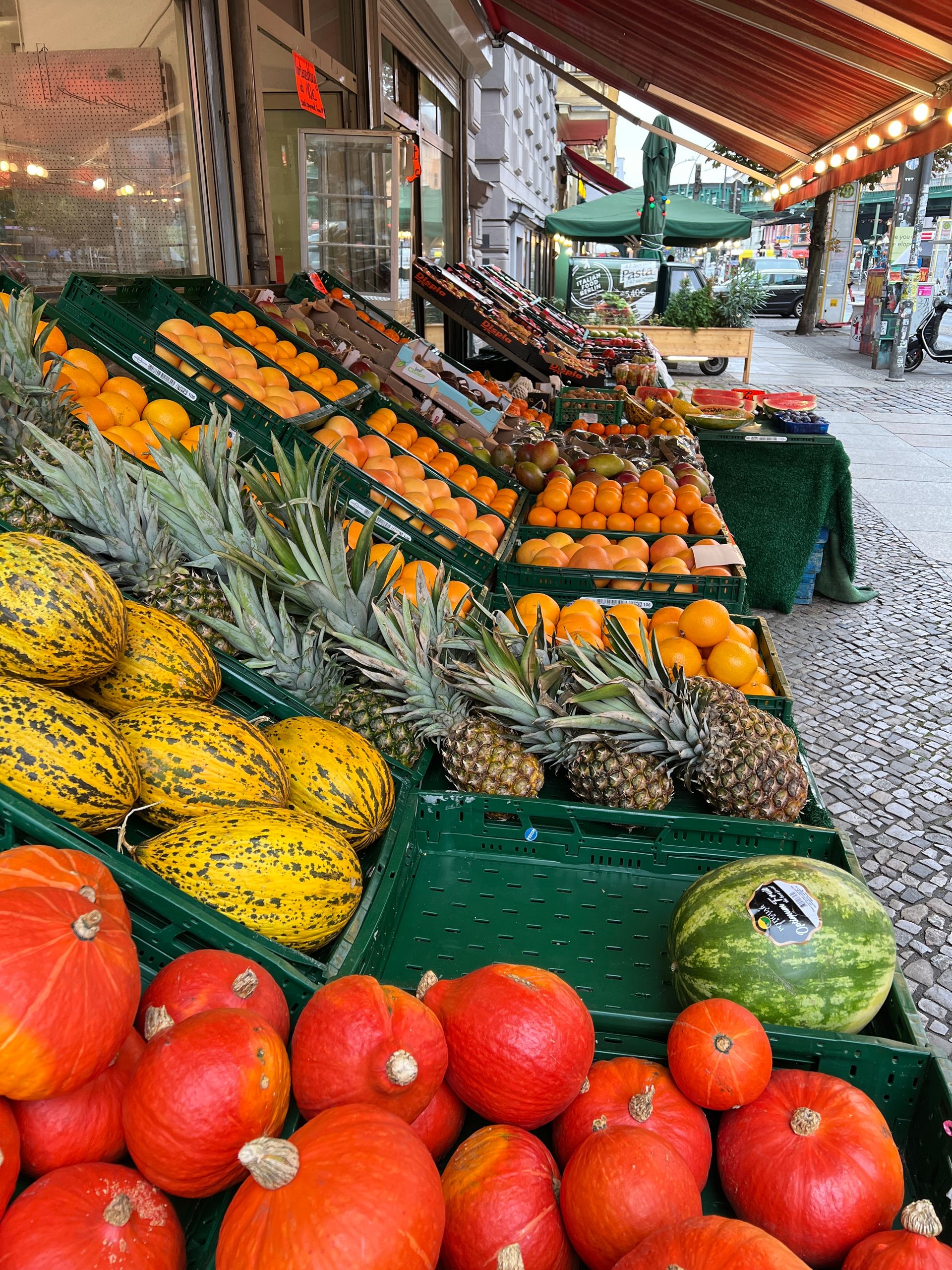 Colorful display of fresh fruits at an outdoor market stall.